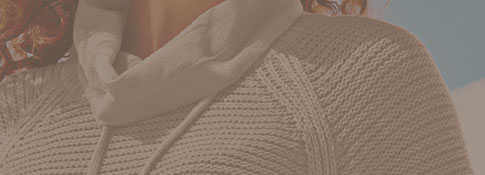 Woman wearing a a taupe sweater.