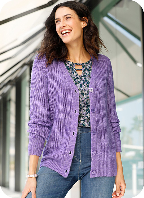 Woman wearing lilac cardigan and dark floral blouse.
