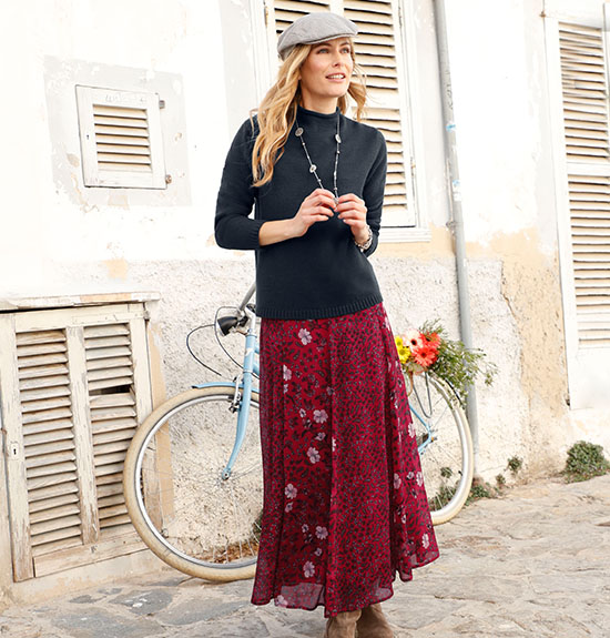 Woman wearing the wine red-printed flowy floral print maxi skirt. 