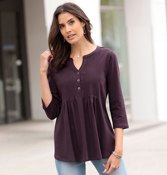 Woman wearing the aubergine pleated button panel top.
