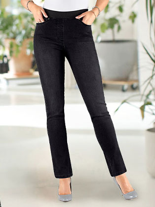 Woman wearing slip on jeans in black denim.