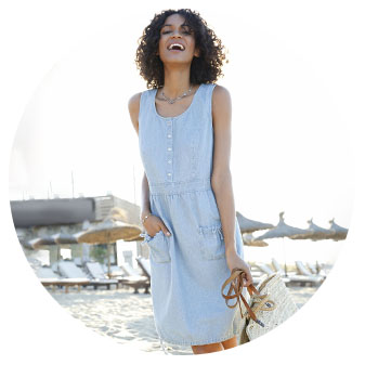 Woman wearing the Denim Look Drawstring Dress in the Fade color.