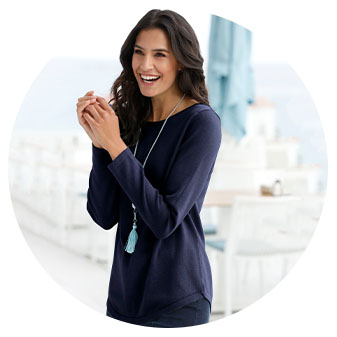 Woman wearing the turquoise ribbed hem sweater.