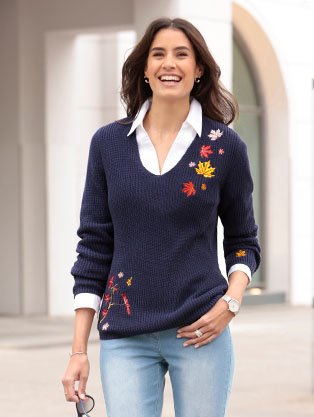 Woman wearing the night blue-rust red leaf embroidered knit sweater.