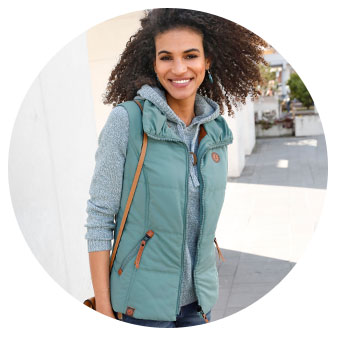 Woman wearing the jade quilted vest.