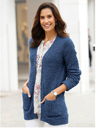 Woman wearing a blue textured cardigan.